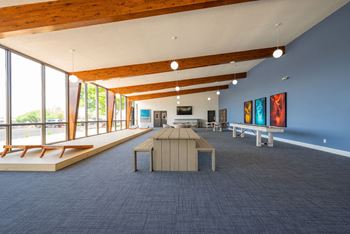 a large room with a large table and benches